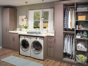 Closet Solutions custom build cabinets, counter top and storage for laundry and cleaning.