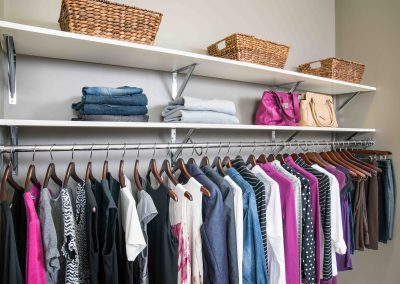 Wood shelving with baskets for closet organization ideas.